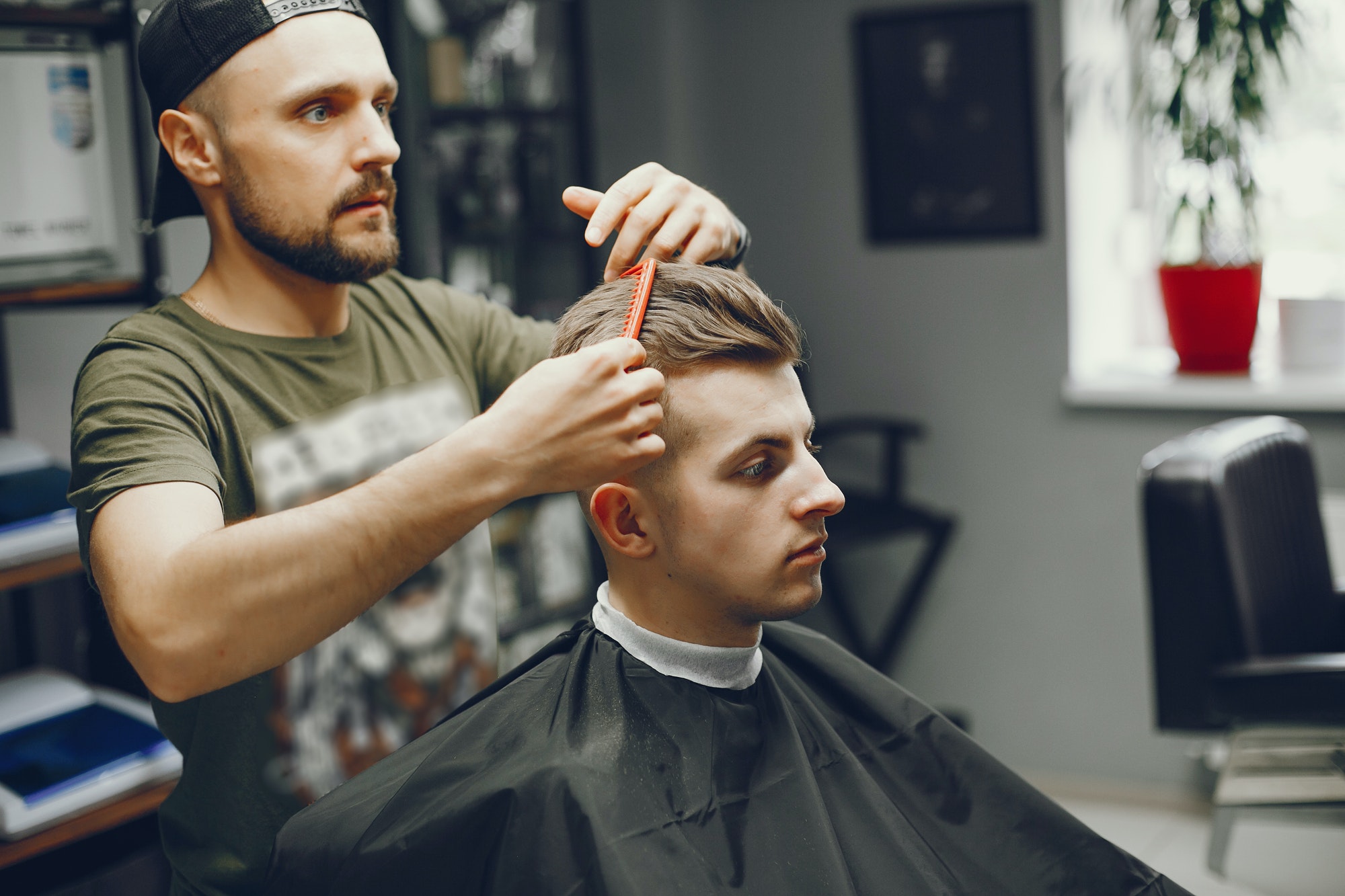 a man cuts hair in a barbershop